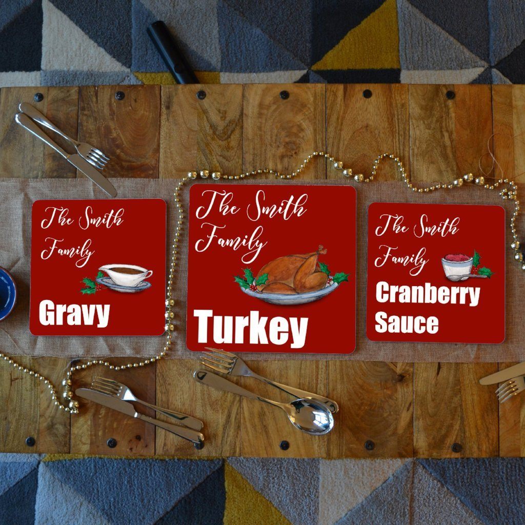 3 personalised Christmas placemats with turkey, gravy and cranberry sauce illustrations on them 