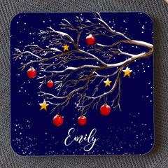 A dark blue personalised square coaster with a winter tree design, the coaster is personalised with the name "Emily"